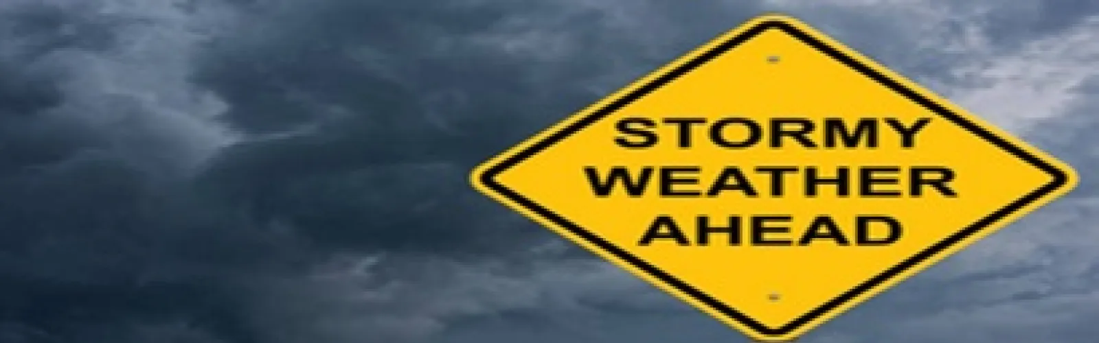 Stormy Weather Ahead sign in front of dark, cloudy sky